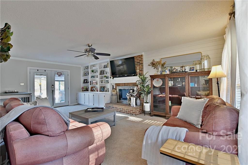 2984 Timber Ridge Lane Rock Hill, SC 29732 - Photo 7 of 32 a living room with furniture a flat screen tv and a large window