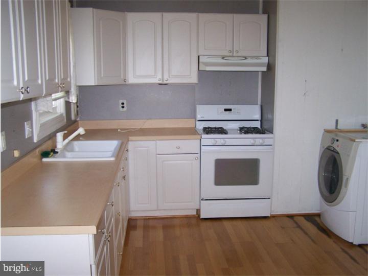 101 Nathaniel Road Newark, DE 19713 - Photo 6 of 13 a kitchen with granite countertop white cabinets and white appliances