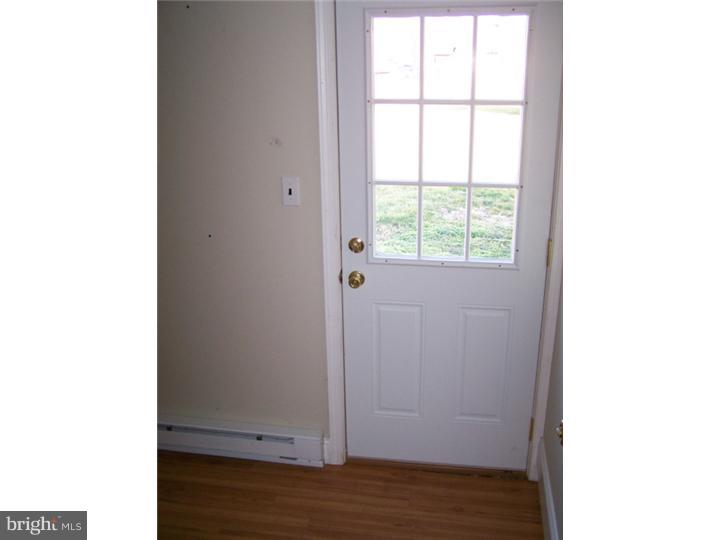 101 Nathaniel Road Newark, DE 19713 - Photo 8 of 13 a view of an empty room with wooden floor and a window
