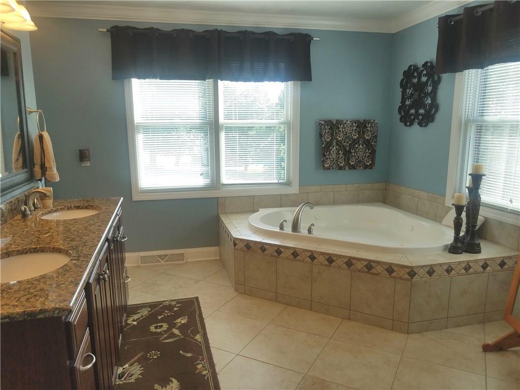 2092 Baughman Road Jeannette, PA 15644 - Photo 15 of 25 MASTER BATH FEATURES DOUBLE BOUL SINKS WITH GRANITE COUNTER TOPS,JETTED CORNER TUB,TILE IN THE SHOWER,HEATED FLOORS AND HEATED TOWEL RACK..