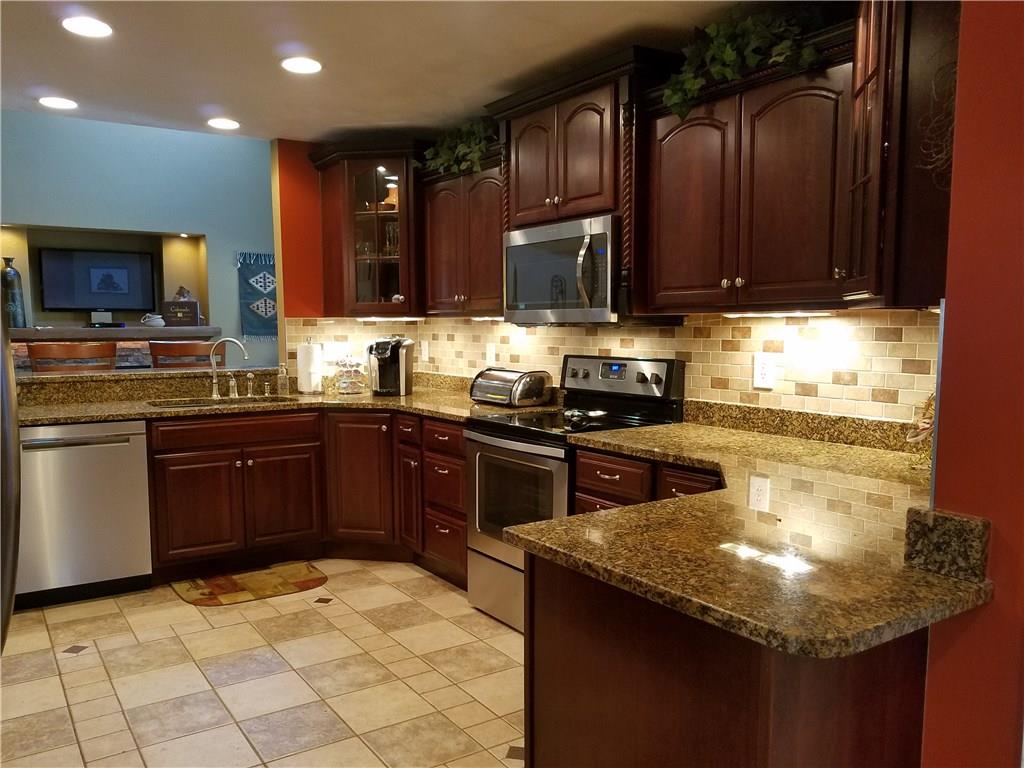 2092 Baughman Road Jeannette, PA 15644 - Photo 7 of 25 KITCHEN IS OPEN TO THE FAMILY ROOM AND FEATURES STAINLESS APPLIANCE,GRANITE COUNTER TOPS AND CERAMIC TILE FLOORING WITH TILE BACKSPLASH!