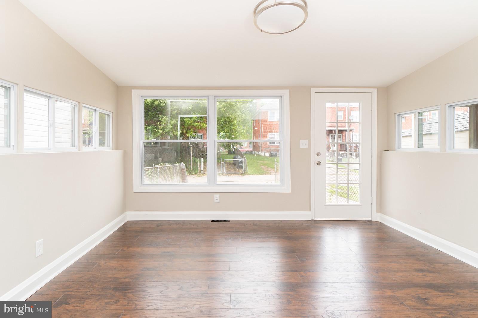 2113 Coralthorn Road Baltimore, MD 21220 - Photo 11 of 24 a view of an empty room with wooden floor and a window