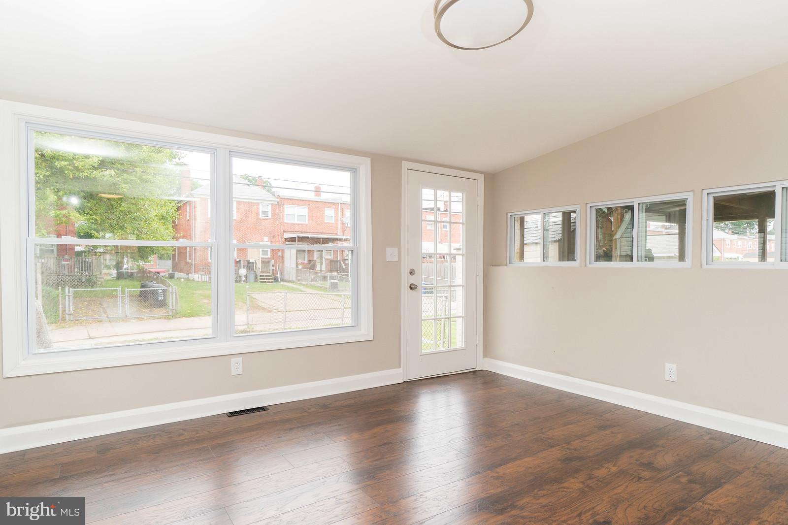 2113 Coralthorn Road Baltimore, MD 21220 - Photo 12 of 24 a view of an empty room with wooden floor and a window