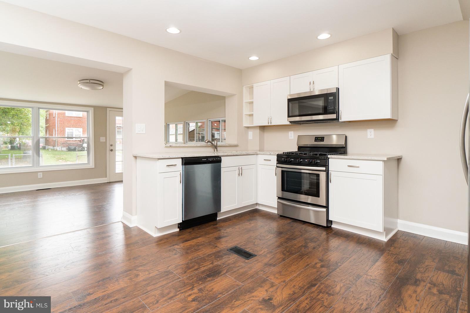 2113 Coralthorn Road Baltimore, MD 21220 - Photo 13 of 24 a kitchen with stainless steel appliances a stove top oven and a sink