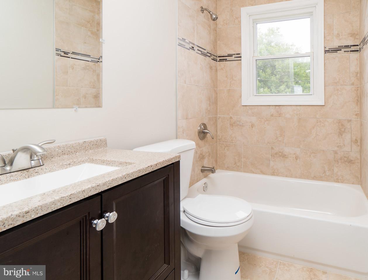 2113 Coralthorn Road Baltimore, MD 21220 - Photo 19 of 24 a bathroom with a granite countertop sink toilet and shower