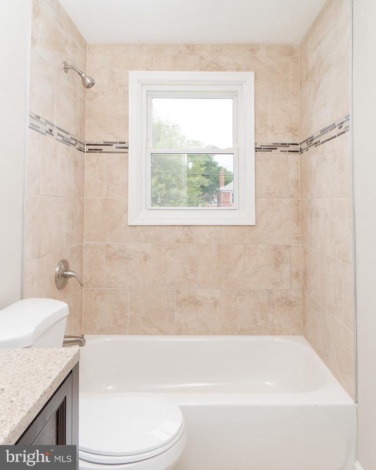 2113 Coralthorn Road Baltimore, MD 21220 - Photo 20 of 24 a bathroom with a granite countertop bathtub shower sink vanity and toilet