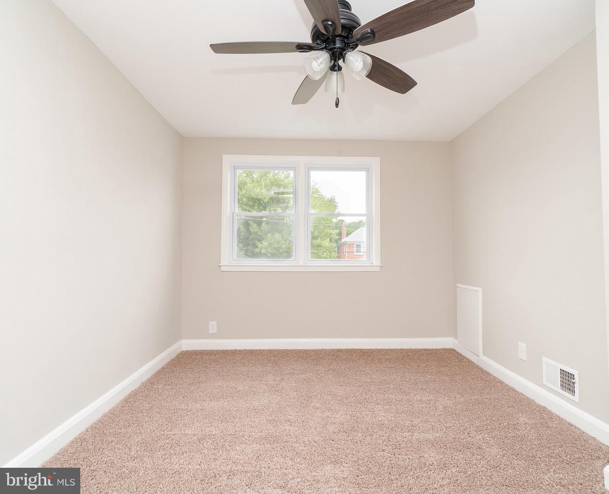 2113 Coralthorn Road Baltimore, MD 21220 - Photo 21 of 24 an empty room with a window and a fan