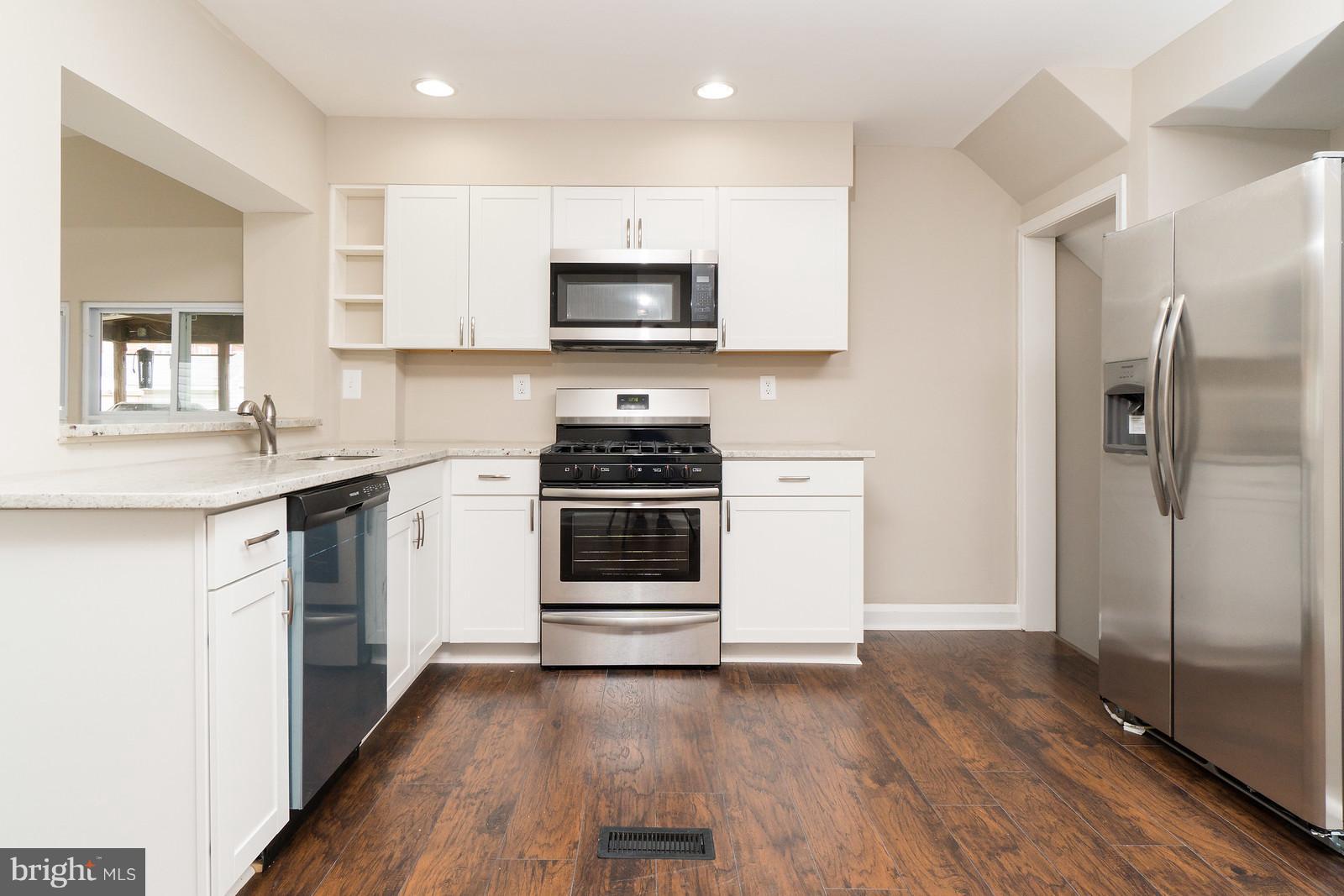 2113 Coralthorn Road Baltimore, MD 21220 - Photo 8 of 24 a kitchen with stainless steel appliances a stove a sink and a refrigerator