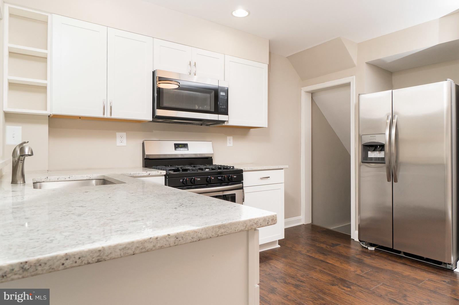 2113 Coralthorn Road Baltimore, MD 21220 - Photo 9 of 24 a kitchen with stainless steel appliances granite countertop a refrigerator stove top oven and sink