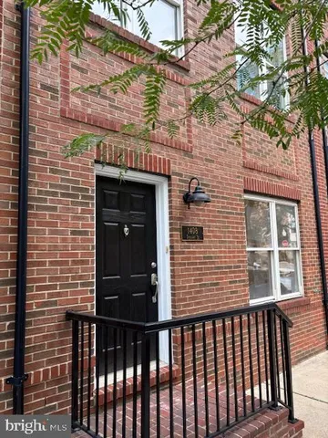 a view of a brick house with a large window