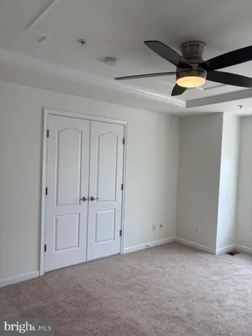 a living room with a chandelier furniture and a ceiling fan