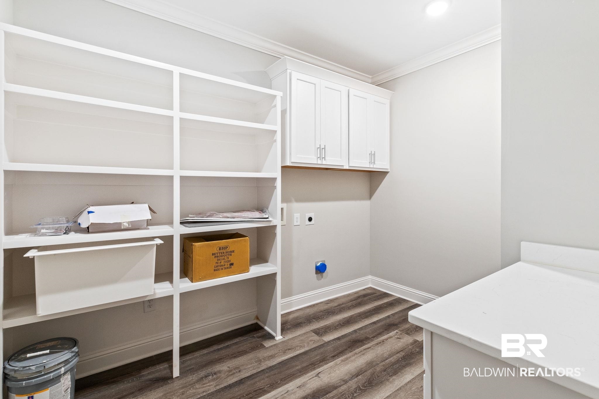 12441 Reunion Place Foley, AL 36535 - Photo 26 of 31 Laundry area featuring cabinets, dark hardwood / wood-style flooring, ornamental molding, and electric dryer hookup