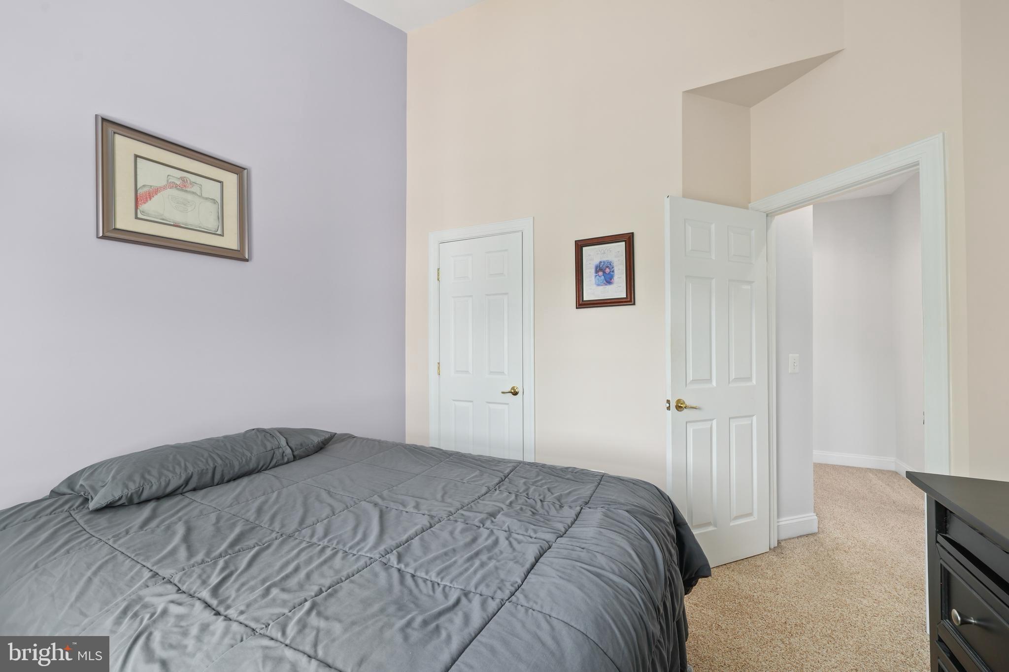 6806 Witton Circle Gainesville, VA 20155 - Photo 25 of 47 a bedroom with bed and painting on the wall