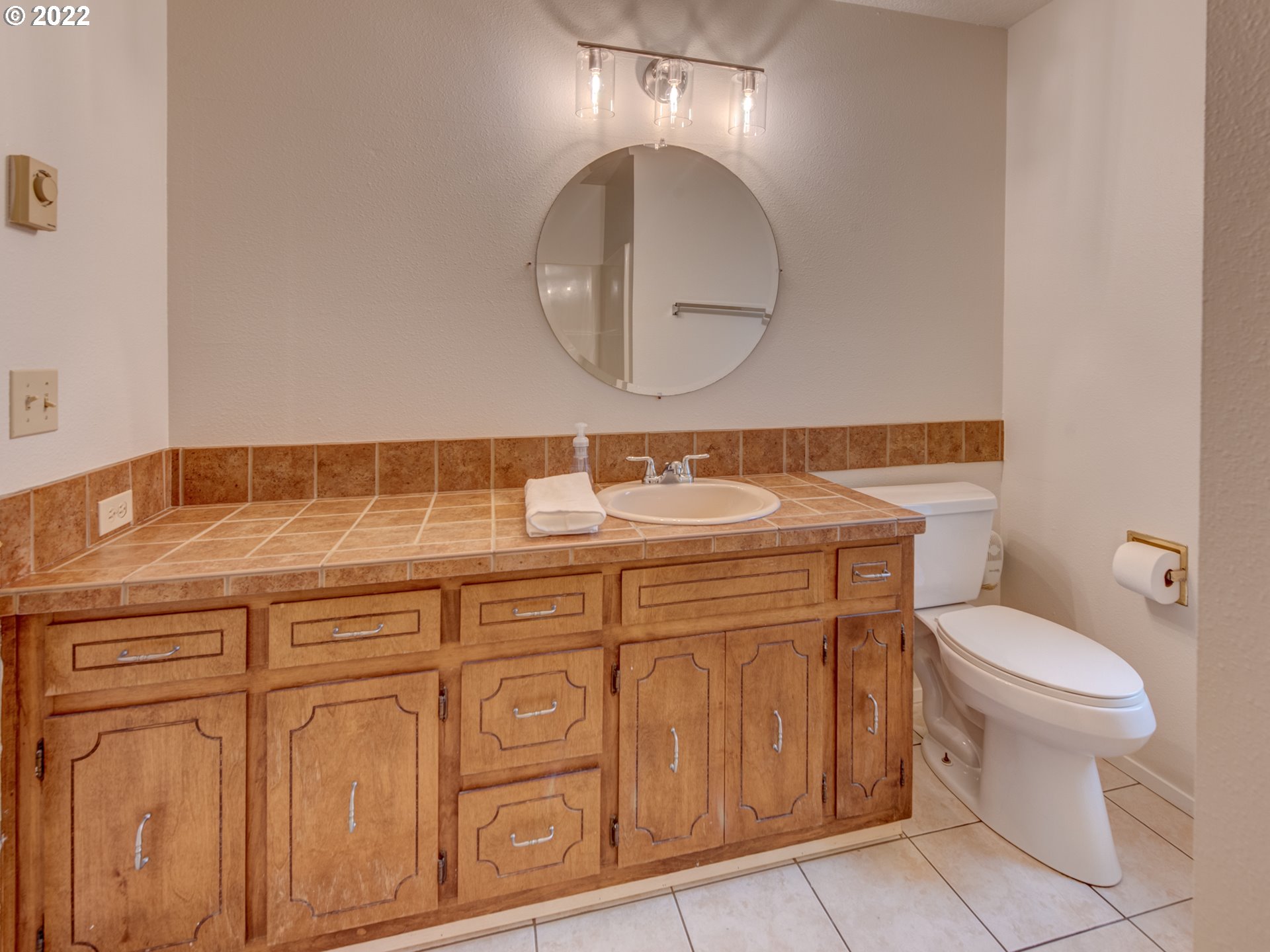 252 71st Street Springfield, OR 97478 - Photo 15 of 30 a bathroom with a sink a toilet and a mirror