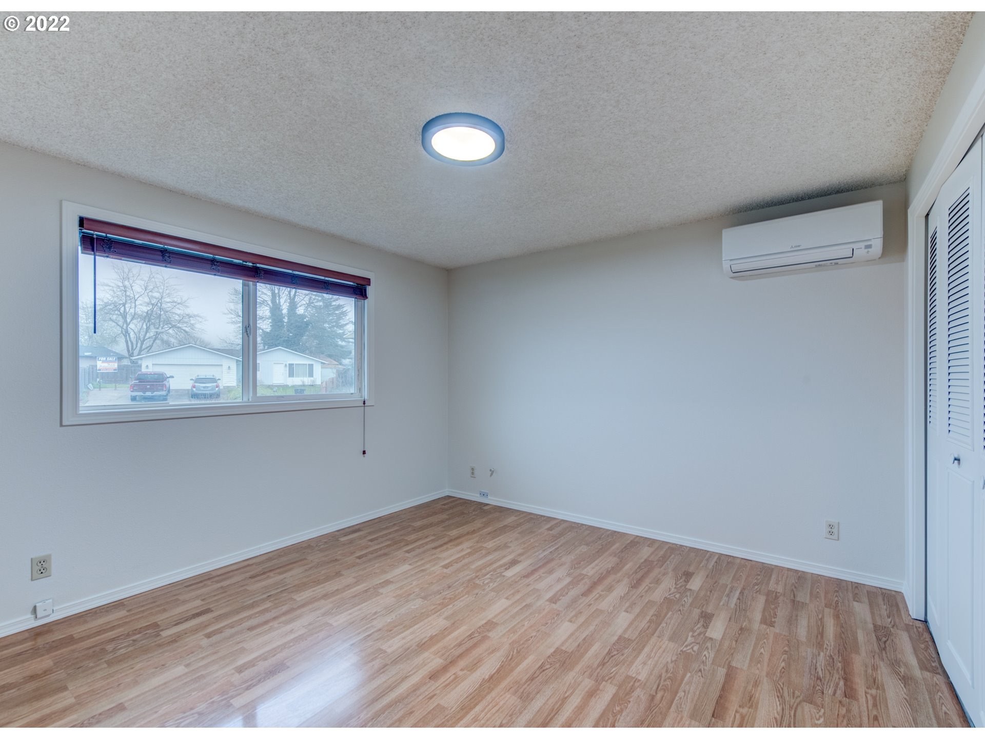 252 71st Street Springfield, OR 97478 - Photo 17 of 30 an empty room with wooden floor and windows