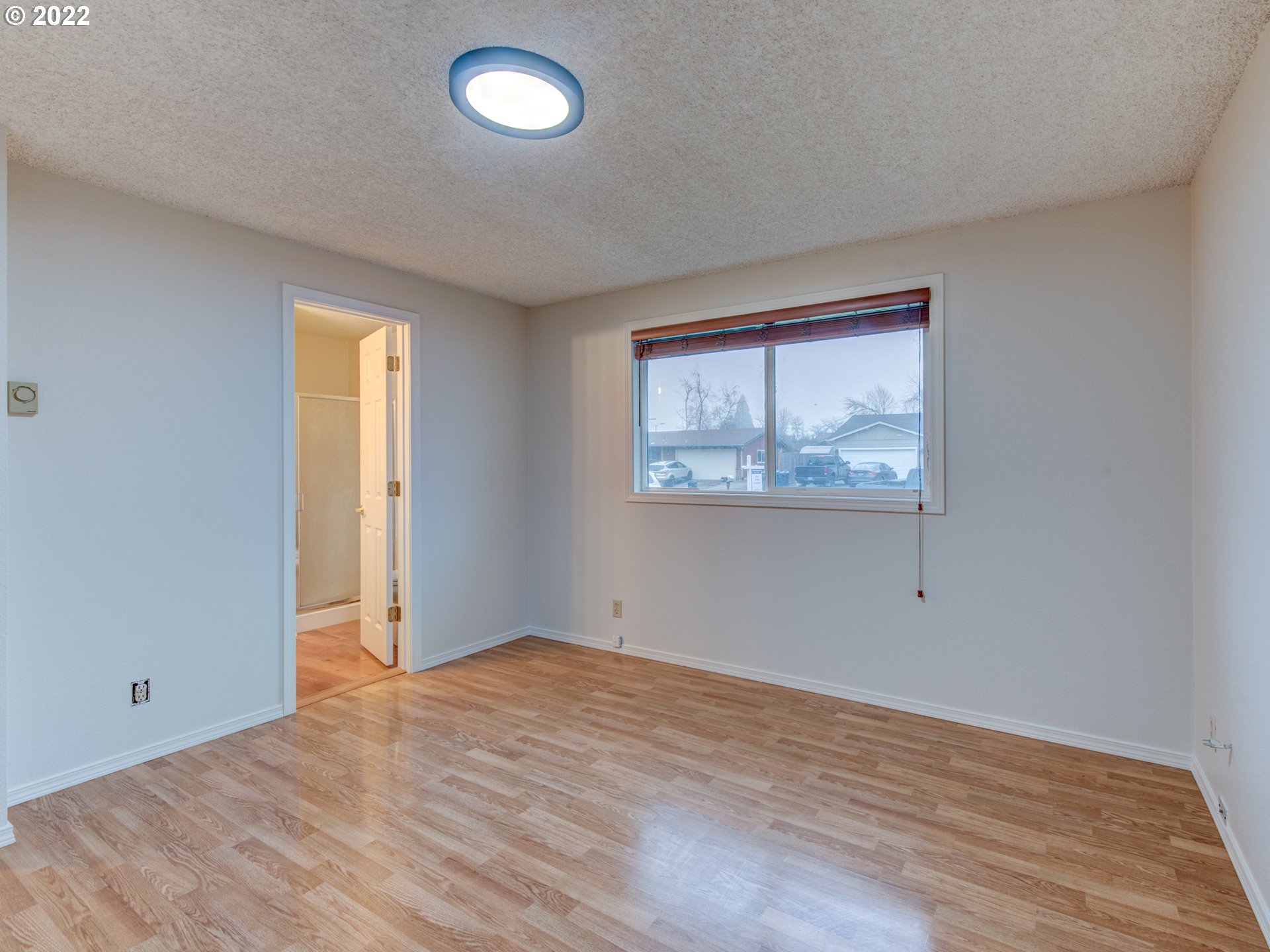 252 71st Street Springfield, OR 97478 - Photo 18 of 30 an empty room with wooden floor and windows