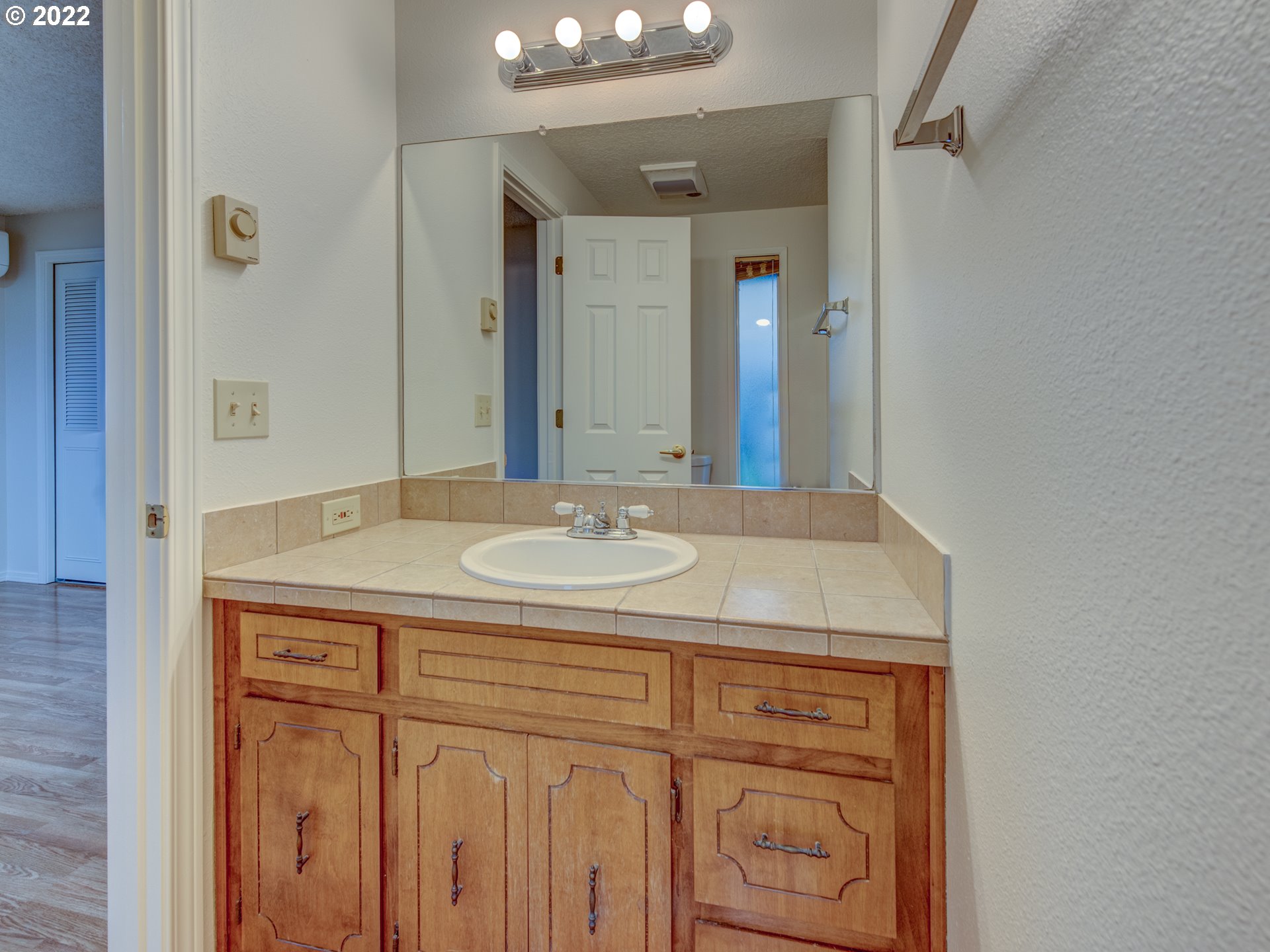 252 71st Street Springfield, OR 97478 - Photo 20 of 30 a bathroom with a sink and a mirror