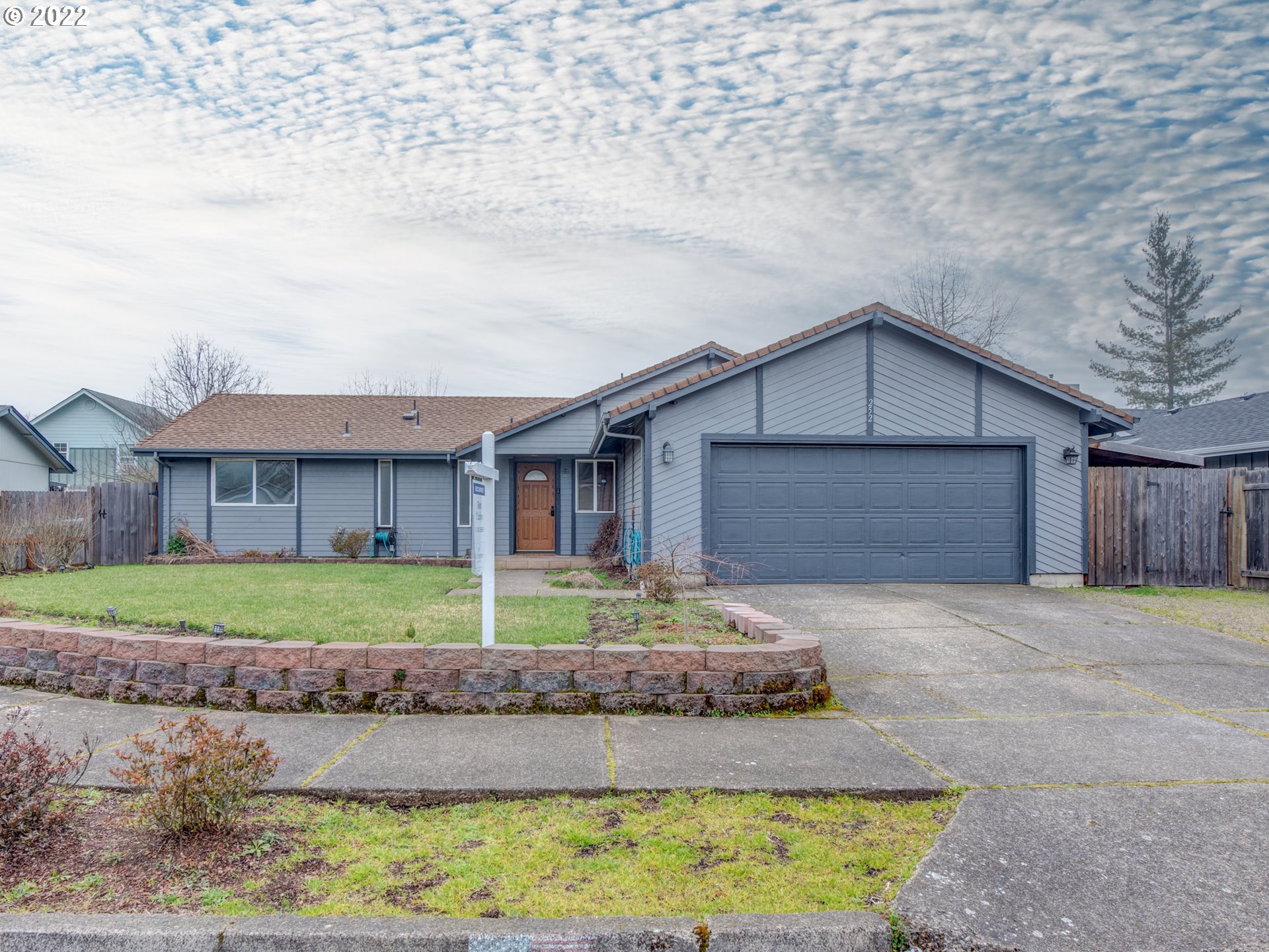 252 71st Street Springfield, OR 97478 - Photo 2 of 30 a front view of a house with a yard and garage