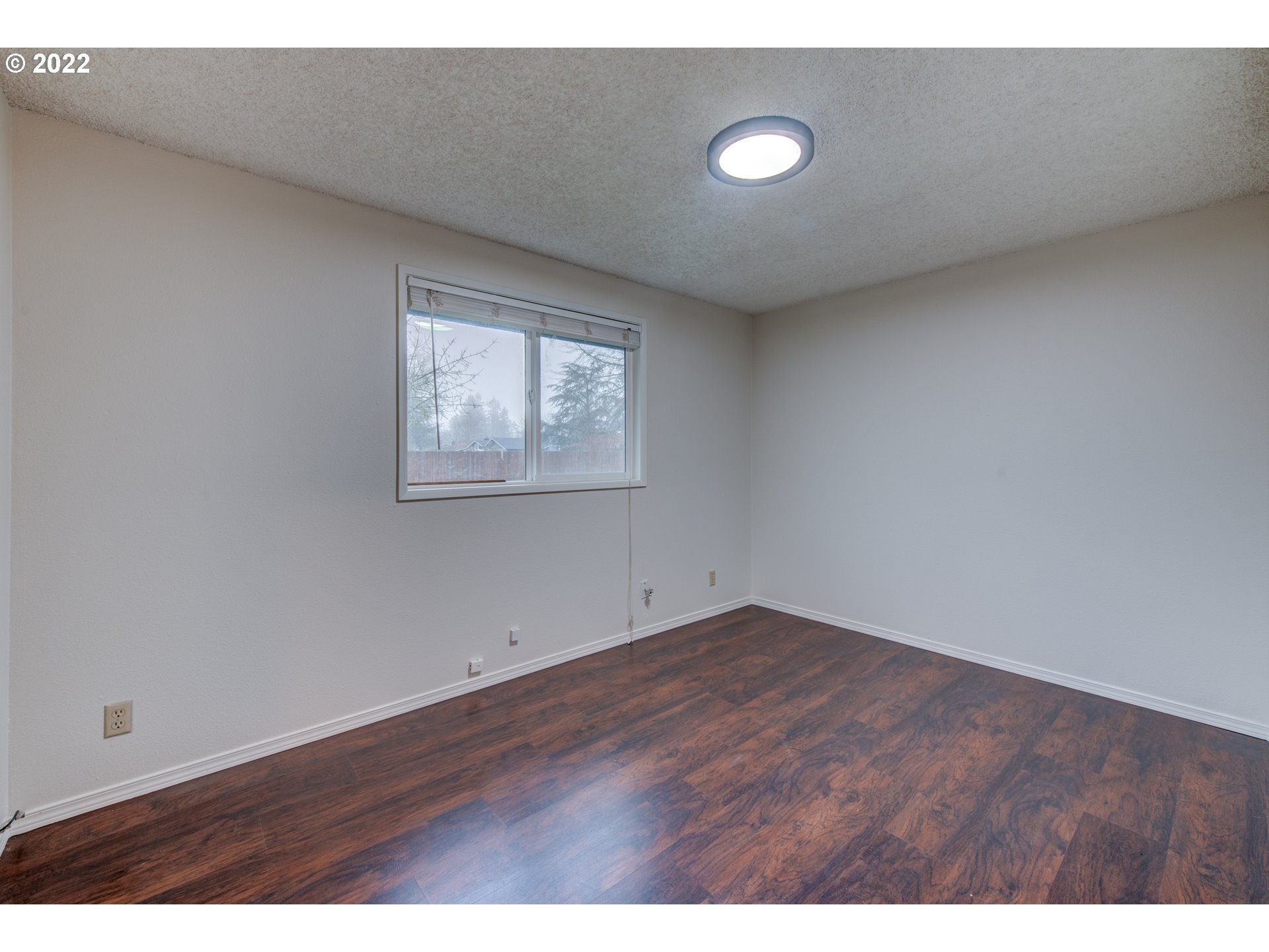 252 71st Street Springfield, OR 97478 - Photo 22 of 30 an empty room with wooden floor and windows
