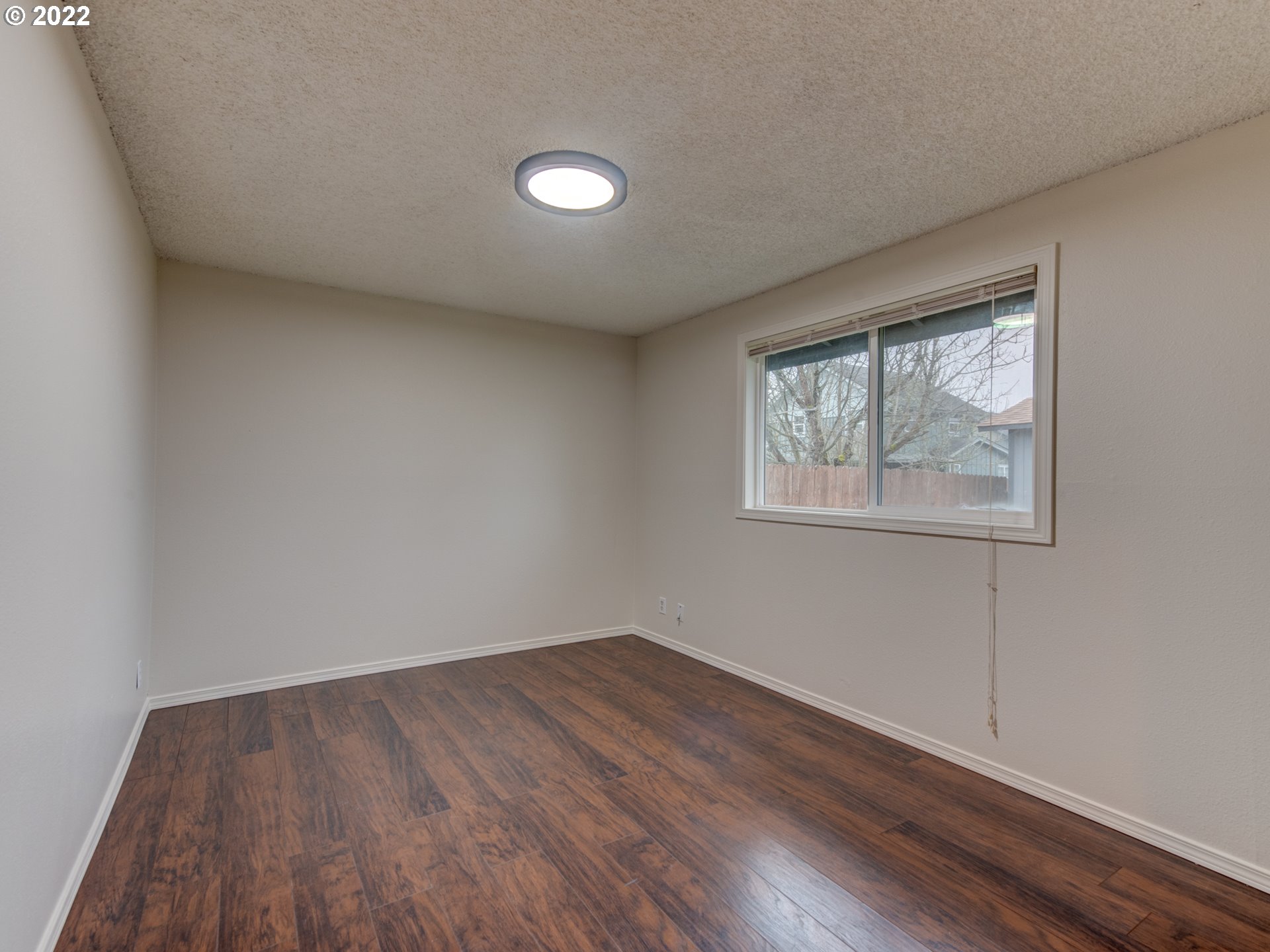 252 71st Street Springfield, OR 97478 - Photo 23 of 30 an empty room with wooden floor and windows