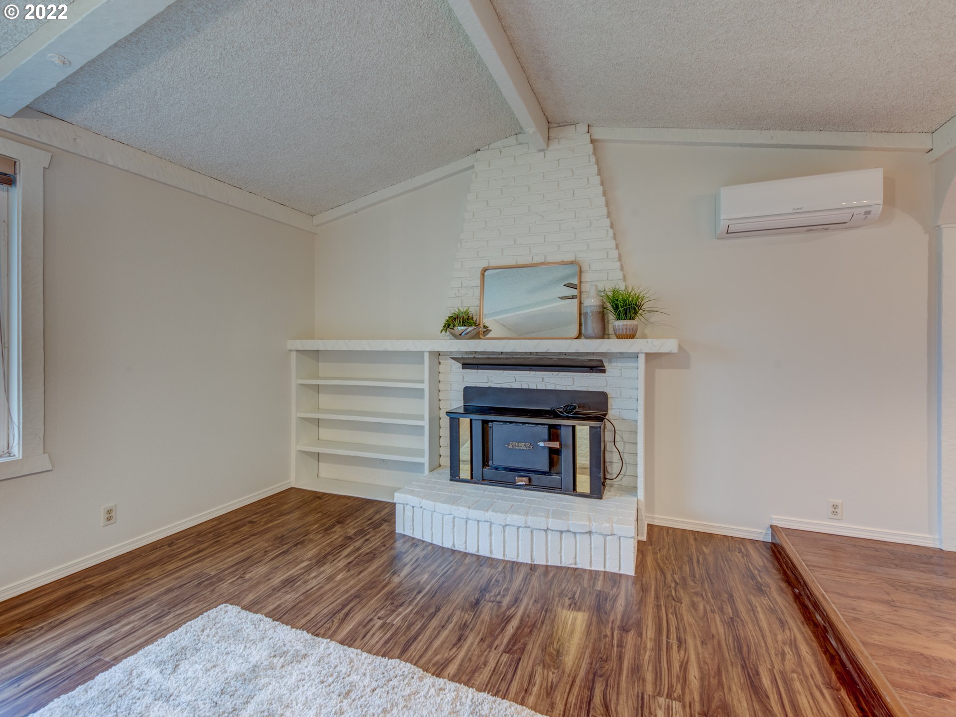 252 71st Street Springfield, OR 97478 - Photo 6 of 30 a view of a livingroom with wooden floor and a fireplace