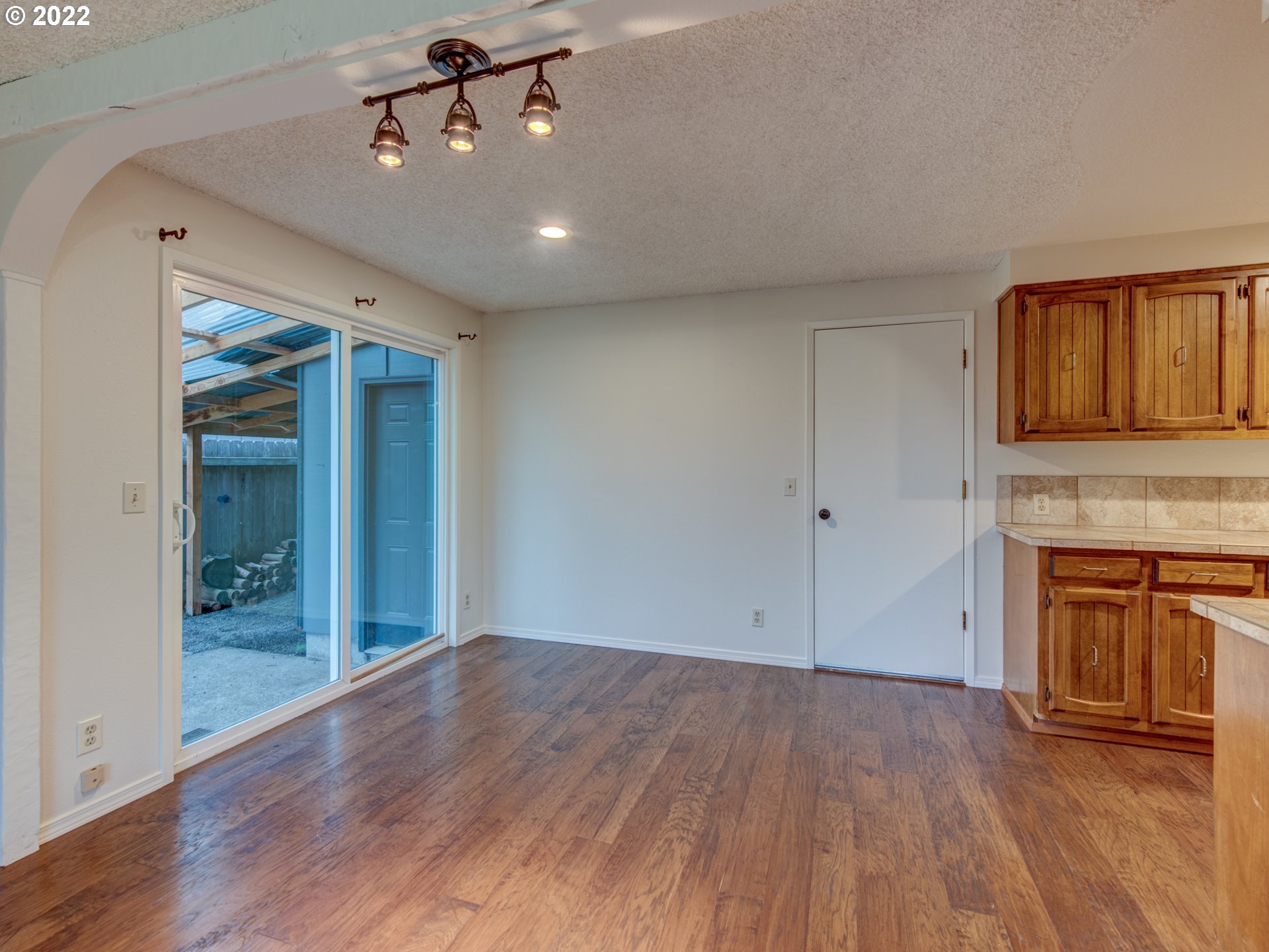 252 71st Street Springfield, OR 97478 - Photo 7 of 30 wooden floor in an empty room with a fireplace