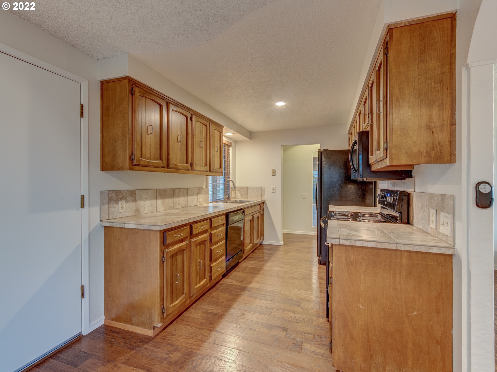 252 71st Street Springfield, OR 97478 - Photo 8 of 30 a kitchen with stainless steel appliances granite countertop a sink stove and refrigerator