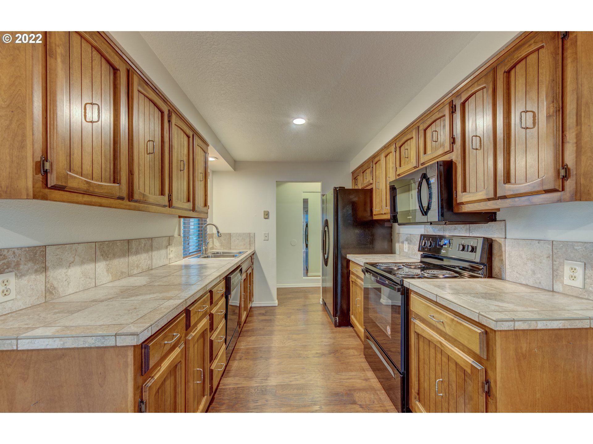 252 71st Street Springfield, OR 97478 - Photo 9 of 30 a kitchen with stainless steel appliances granite countertop a sink stove and cabinets