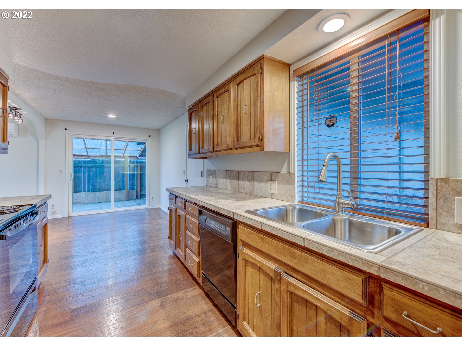252 71st Street Springfield, OR 97478 - Photo 10 of 30 a kitchen with stainless steel appliances granite countertop a sink and a wooden cabinets