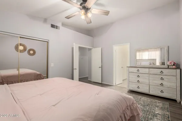 a bedroom with a large bed and a chandelier