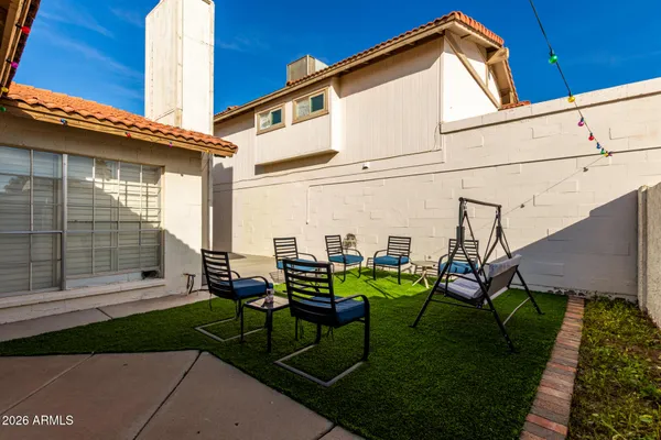a view of a backyard with sitting area