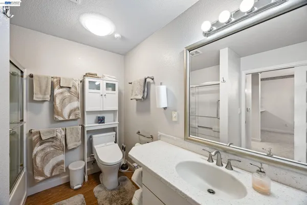 a bathroom with a double vanity sink toilet and shower