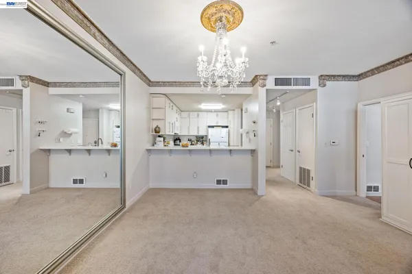 a view of a hallway with chandelier