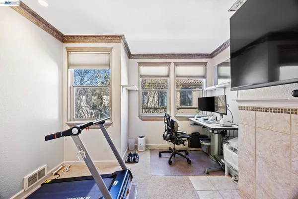 a view of a workspace with furniture and a window