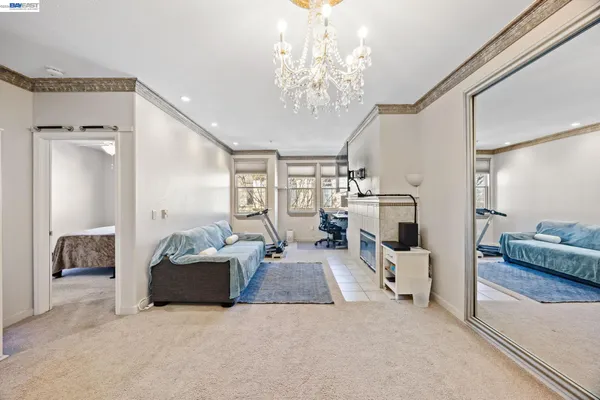 a living room with furniture and a chandelier