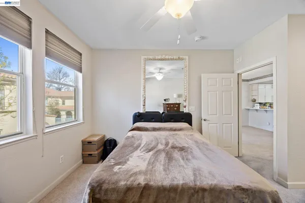 a bedroom with a bed and a window