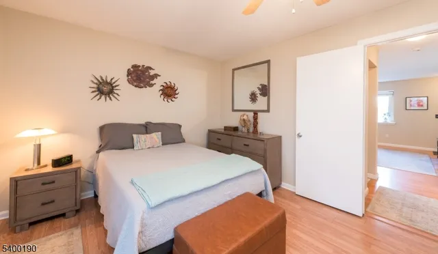 a spacious bedroom with a bed and a cabinets