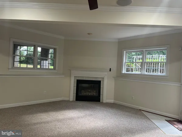 a living room with a fireplace and a window