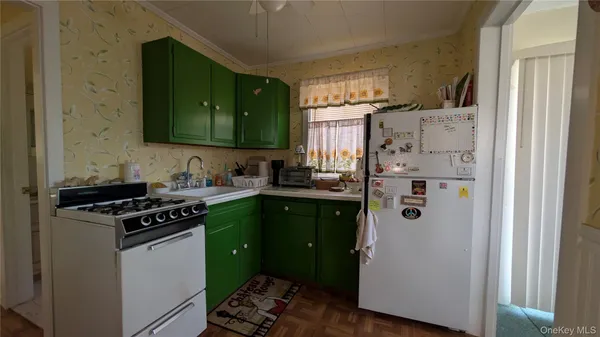 a kitchen with a refrigerator sink and cabinets