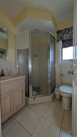 a spacious bathroom with a granite countertop sink a toilet and shower
