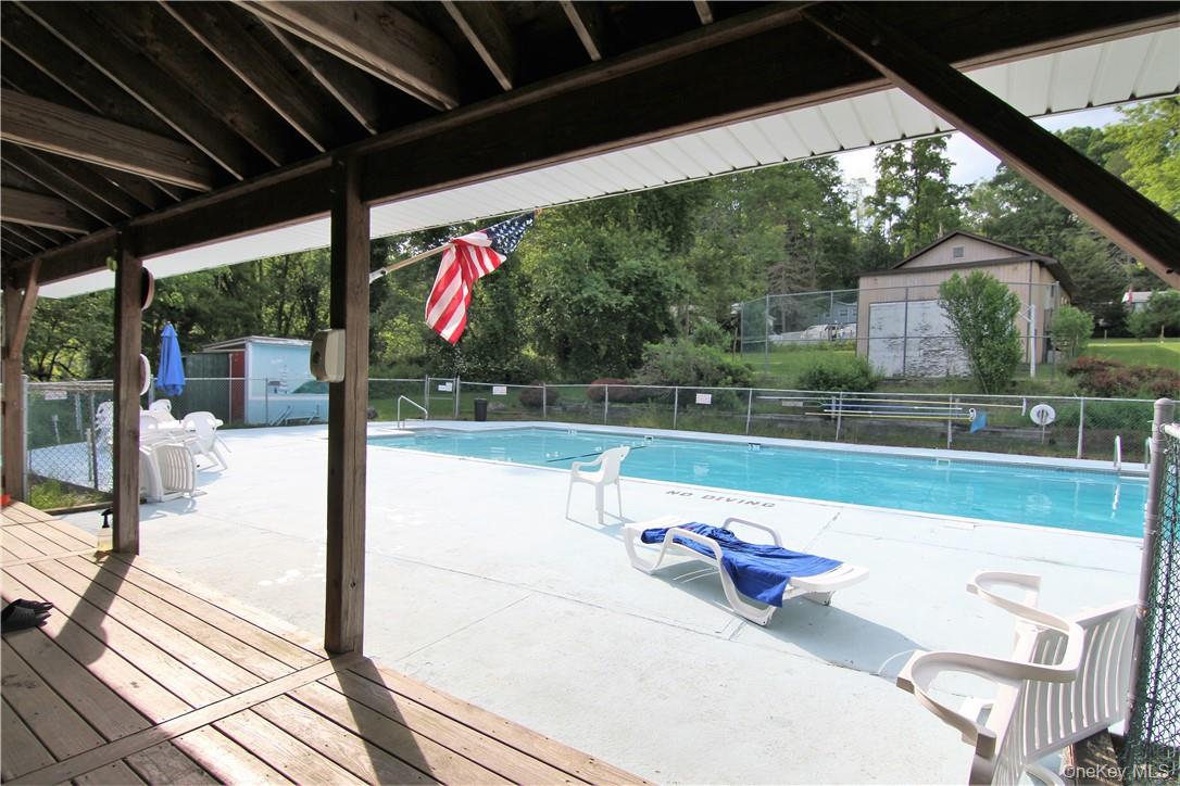 191 Sylvan Lake Road, Unit 5 Hopewell Junction, NY 12533 - Photo 25 of 28 a view of a porch with furniture and garden