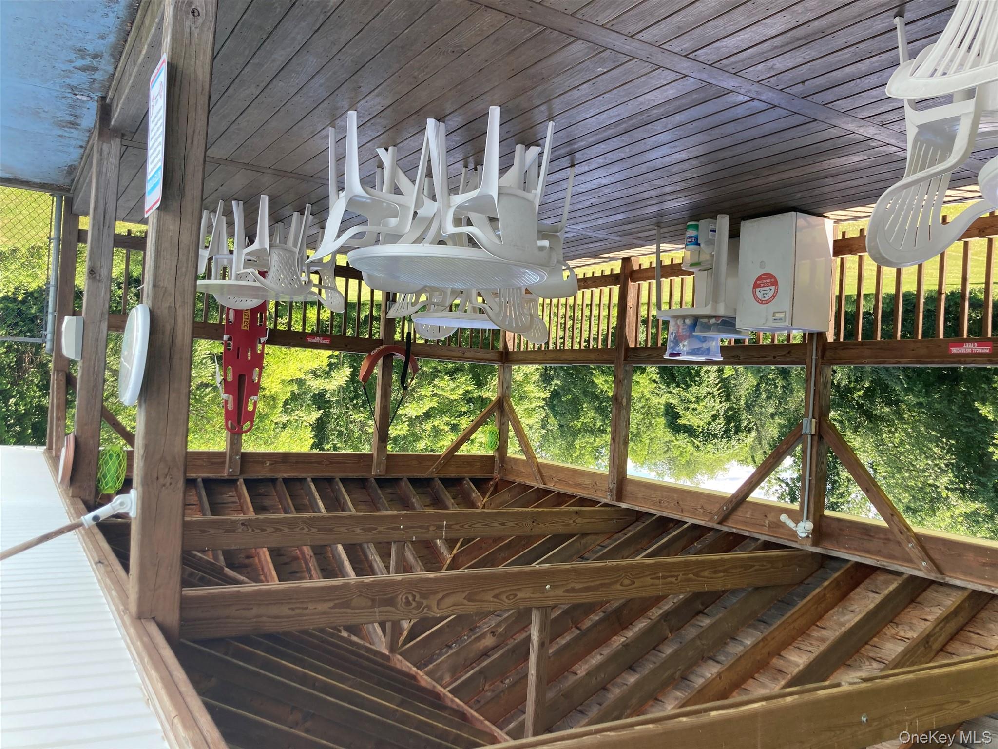 191 Sylvan Lake Road, Unit 5 Hopewell Junction, NY 12533 - Photo 27 of 28 a view of a chairs and table in patio with wooden floor