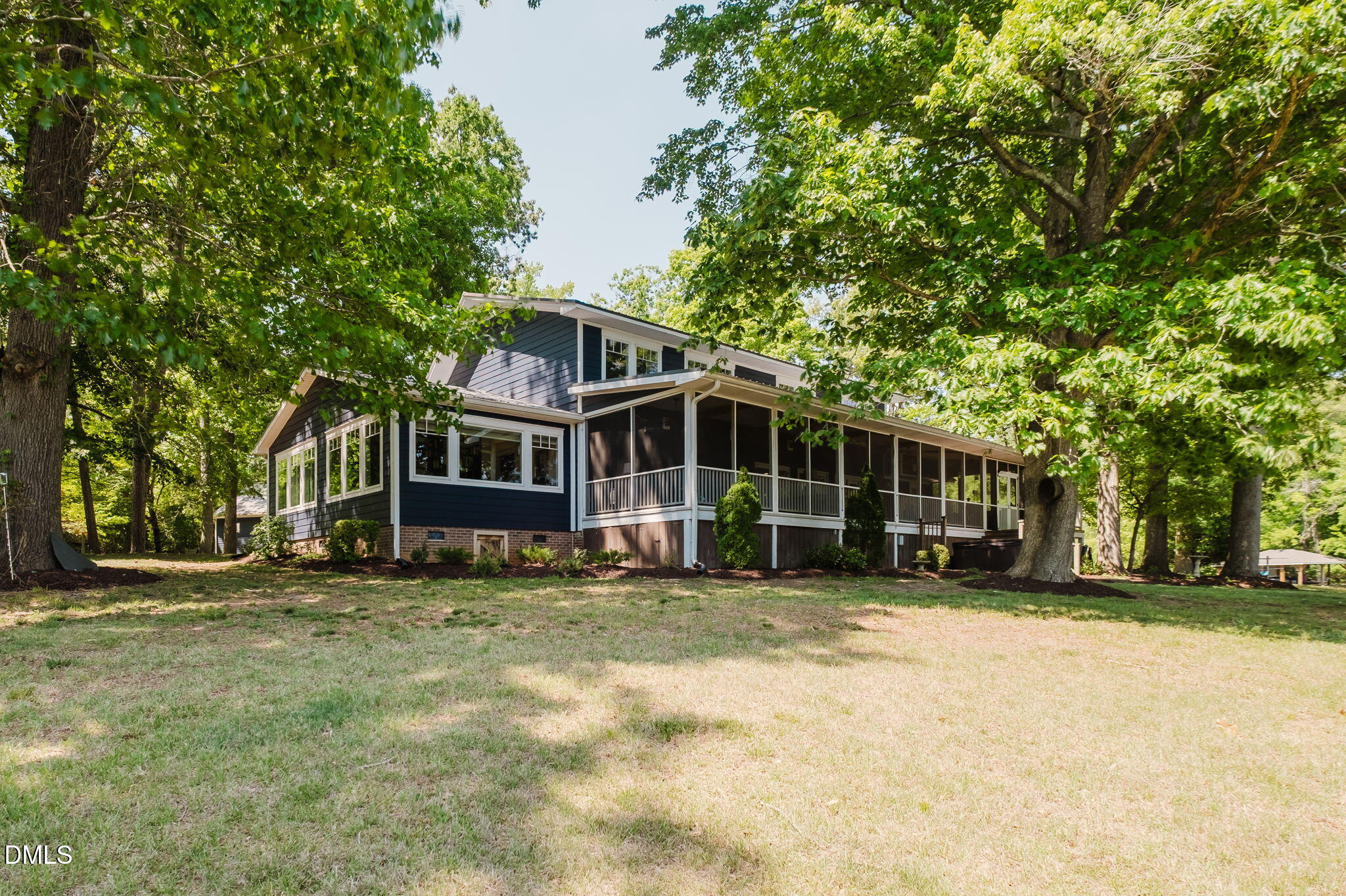 370 Robinson Ferry Road Macon, NC 27551 - Photo 62 of 85 a view of a house with a big yard and large trees