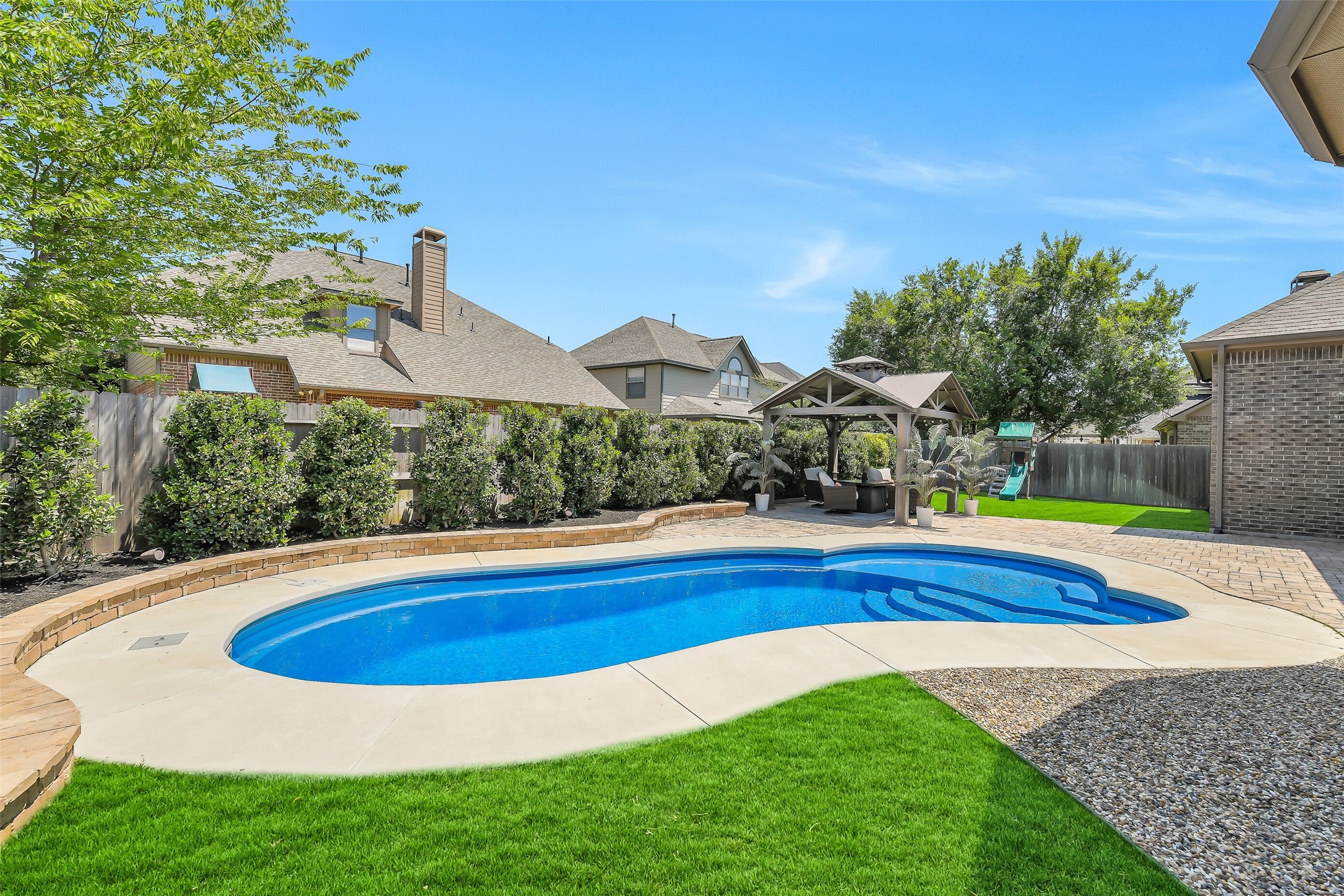 12207 Shorebridge Road Cypress, TX 77433 - Photo 38 of 41 a view of pool with table and chairs under an umbrella