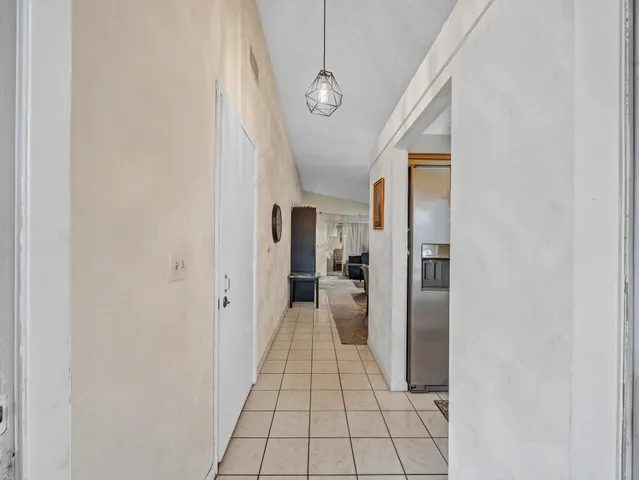 a hallway with a white stove top oven and refrigerator