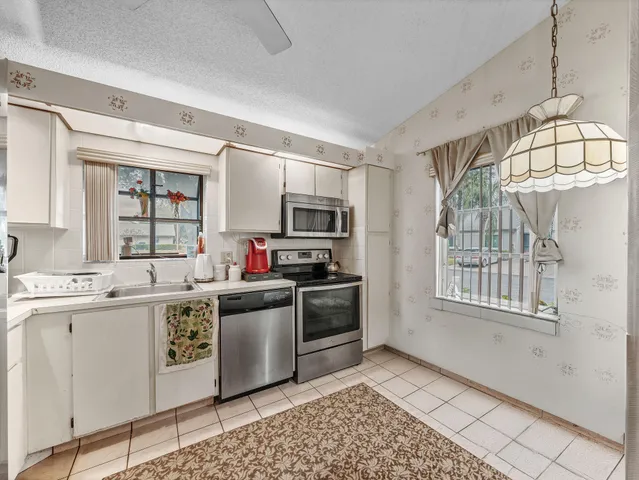a kitchen with stainless steel appliances granite countertop a stove and a sink