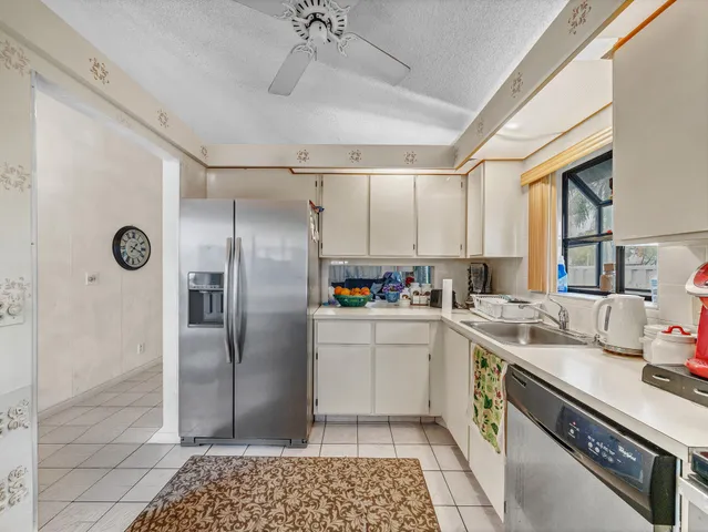 a kitchen with a table chairs refrigerator and microwave