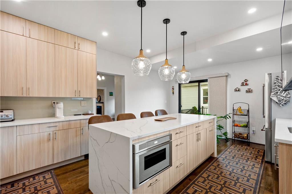 1520 4th Avenue Coraopolis, PA 15108 - Photo 11 of 37 a kitchen that has a lot of white cabinets and stainless steel appliances