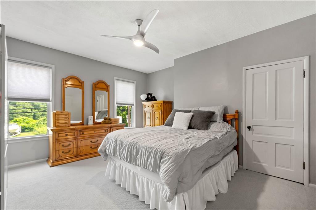 1520 4th Avenue Coraopolis, PA 15108 - Photo 23 of 37 a bedroom with a large bed and wooden floor