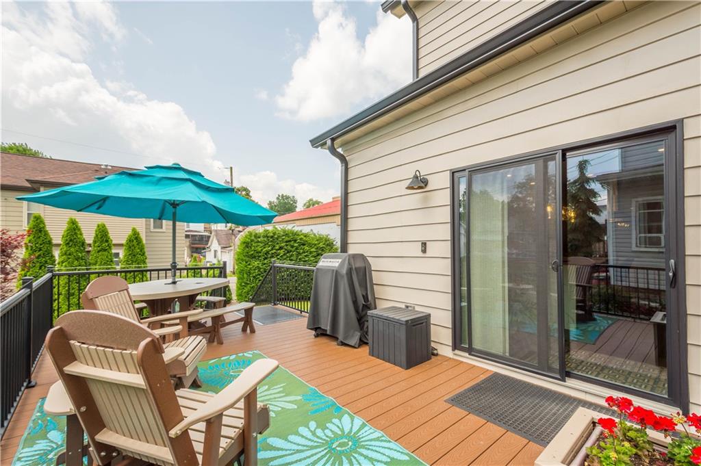 1520 4th Avenue Coraopolis, PA 15108 - Photo 35 of 37 a patio with a table and chairs under an umbrella